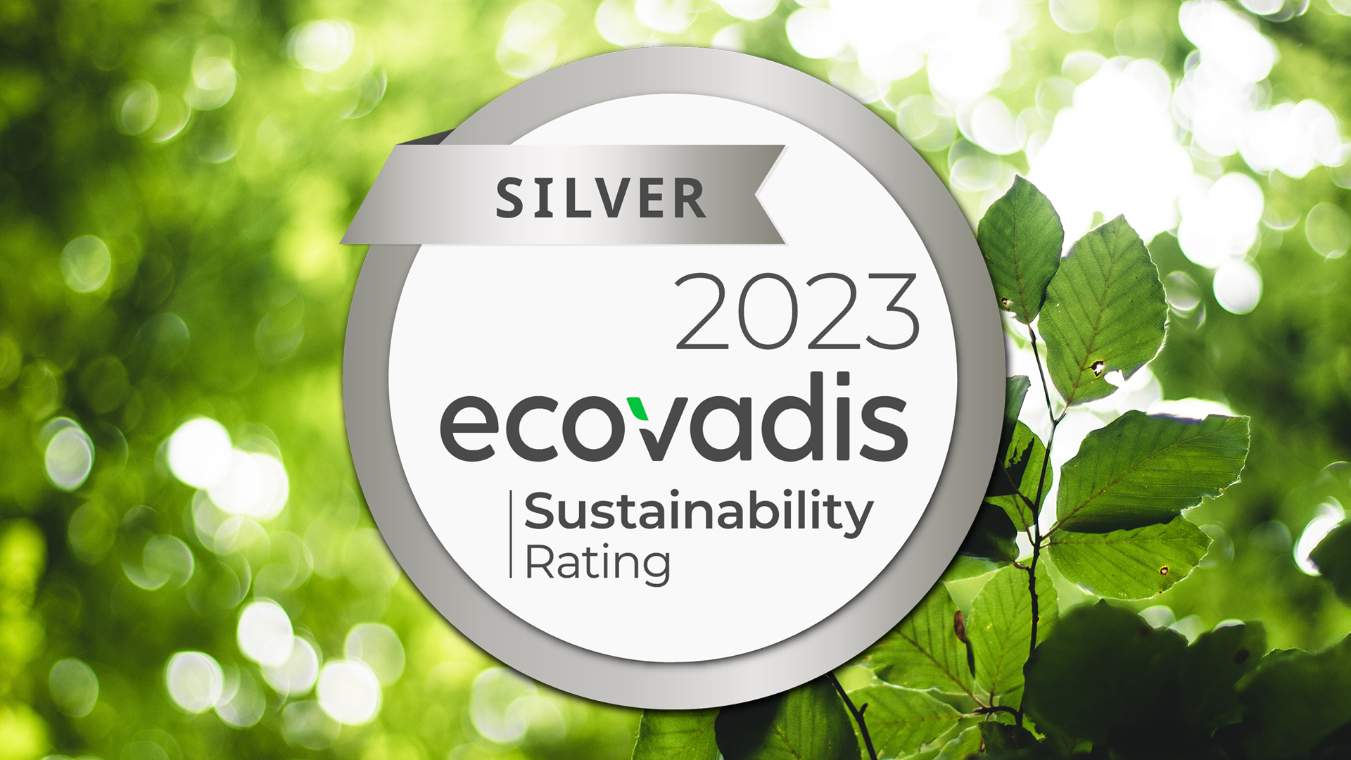 Ecovadis Sustainability Management circular silver award logo with a background of green leaves.
