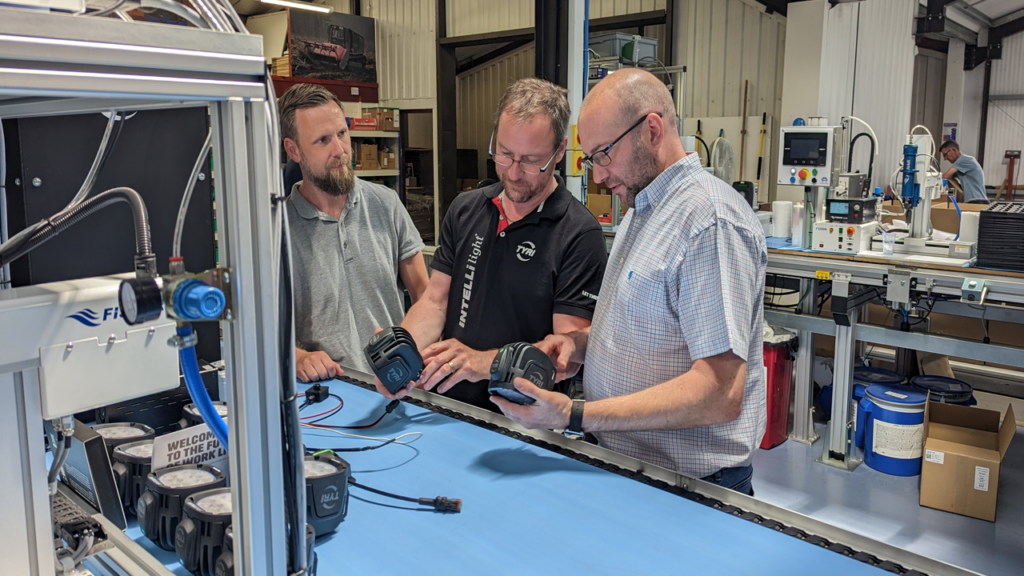 3 Engineers look at and work on the new INTELLilight in the UK manufacturing facility.